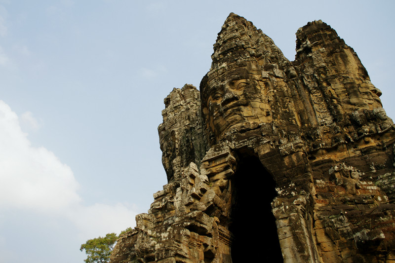 Smiling faces look out from the south gate of Angkor Thom