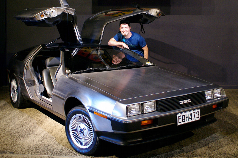 Justin posing with a 1981 DeLorean DMC12 at the WOW Classic Cars Museum in