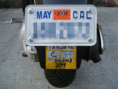 Inspection sticker plate installed, with San Francisco parking permit