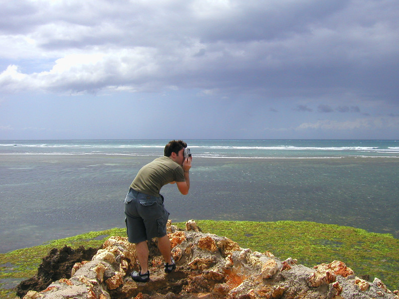 justin taking a picture on the coast in tanzania