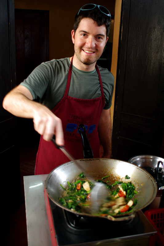 Justin stir-frying at the Tamnak Lao cooking class in Luang Prabang, Laos