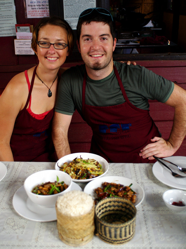 Stephanie and Justin sitting down to dinner at the Tamnak Lao cooking class in Luang Prabang, Laos