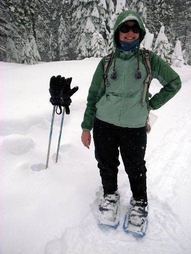 Stephanie in snowshoeing garb, pausing to have lunch