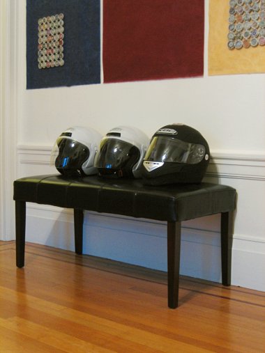 Three helmets on a bench