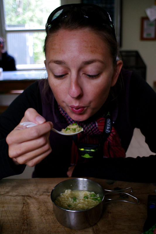 Stephanie eating ramen soup at the Anchorage Hut on the Abel Tasman Coast Track
