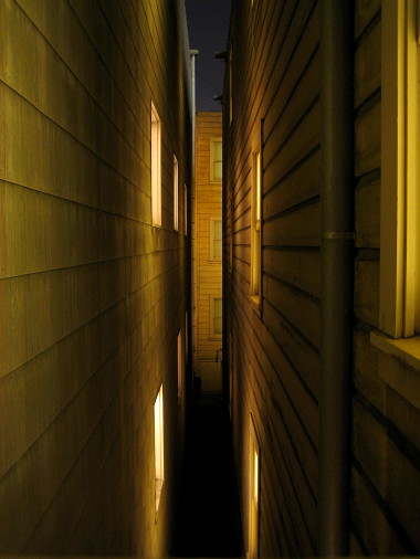 between buildings at night