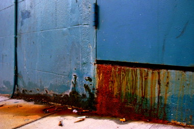 blue door with rusty drips