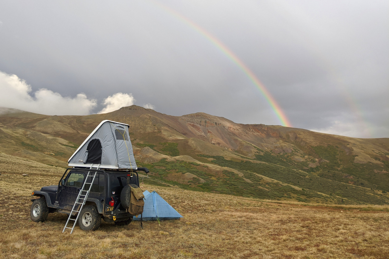 A double rainbow behind my Jeep and Dad's tent at Carson Saddle