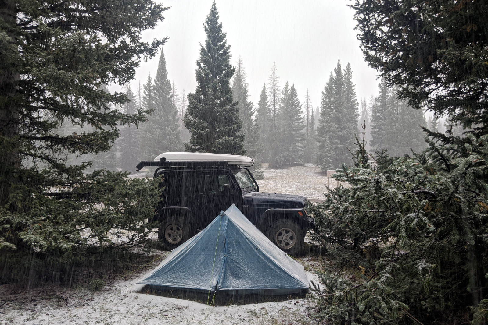 Snow beginning to fall on La Jeep and Dad's tent