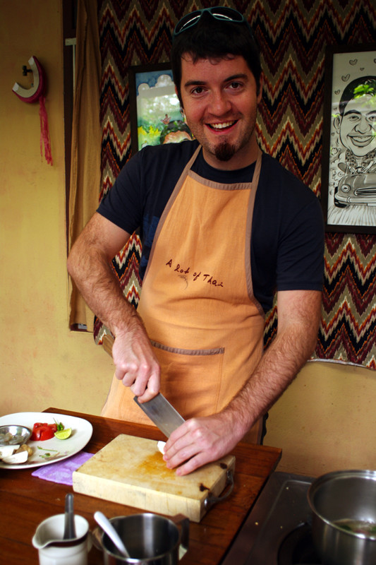 Justin cutting a mushroom at A lot of Thai cooking class in Chiang Mai, Thailand