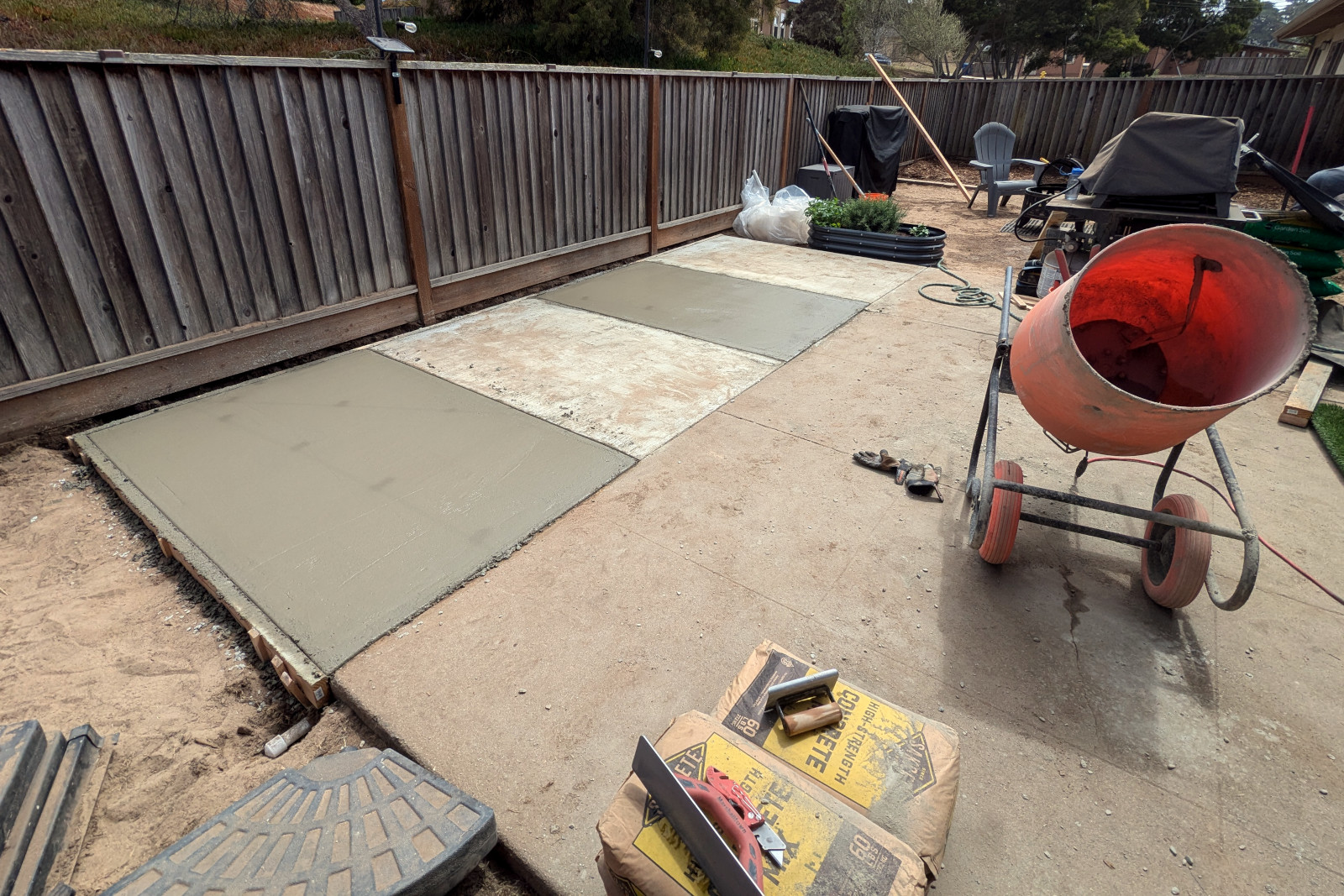 100sqft concrete slab poured in four sections, to extend an existing patio