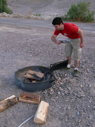 Justin fanning the fire in the firepit