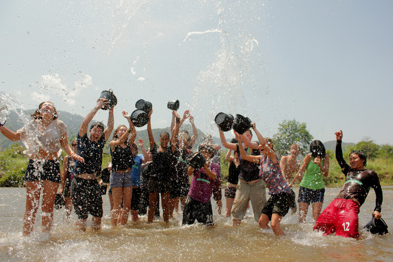 Splashy volunteer group shot in river at Elephant Nature Park in Chiang Mai, Thailand