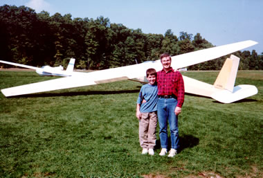 Justin and his dad, Brian, in front of a glider