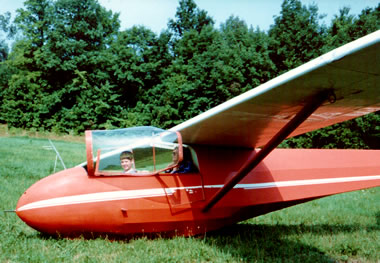 Justin in cockpit of an orange Schweizer SGS 2-33 glider