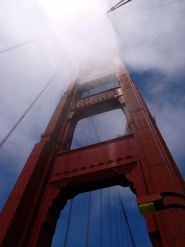 The top of the south tower of the Golden Gate Bridge touching the fog