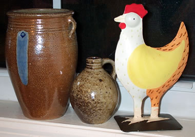 two hewitt pots next to rooster on my windowsill