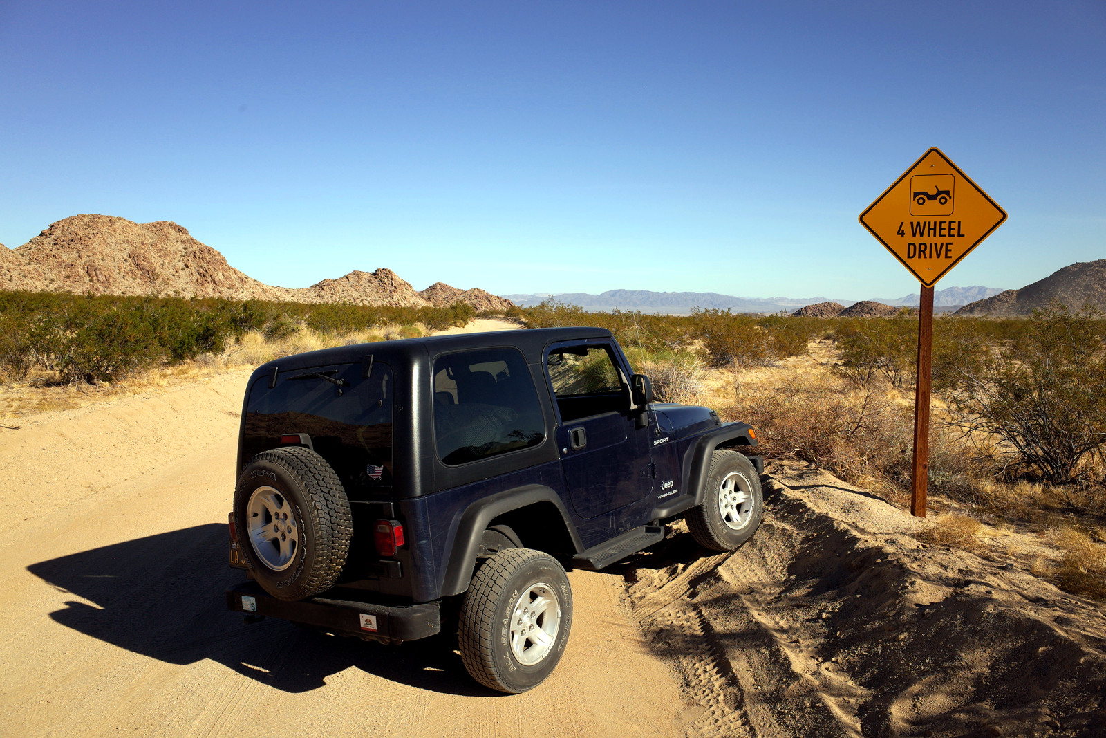 La Jeep posing with the 4 Wheel Drive sign on Old Dale Road in Joshua Tree National Park