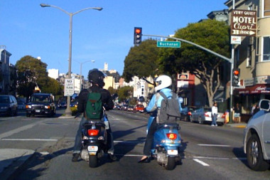 Justin and Stephanie on scooters from behind