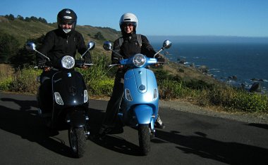 Justin and Stephanie on Vespas overlooking the Pacific on CA-1