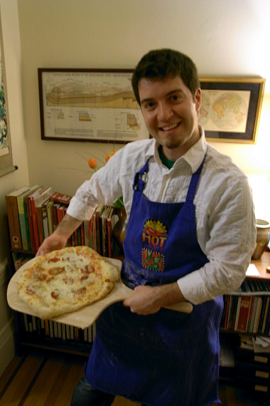 Justin shows off the first pizza: pepperoni