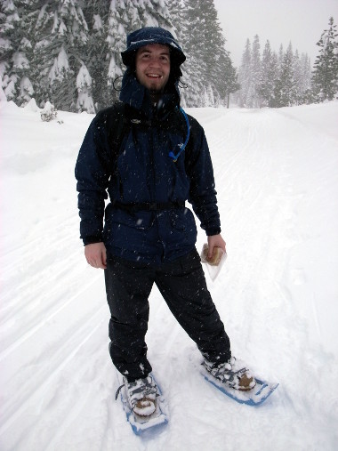 Justin in snowshoeing garb, pausing to have lunch