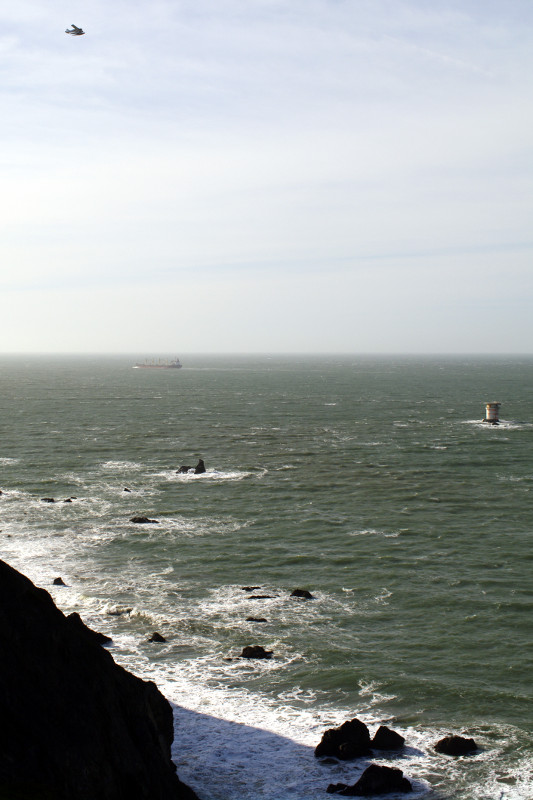 A sea plane, a freighter, and Mile Rock Lighthouse at Land's End, San Francisco