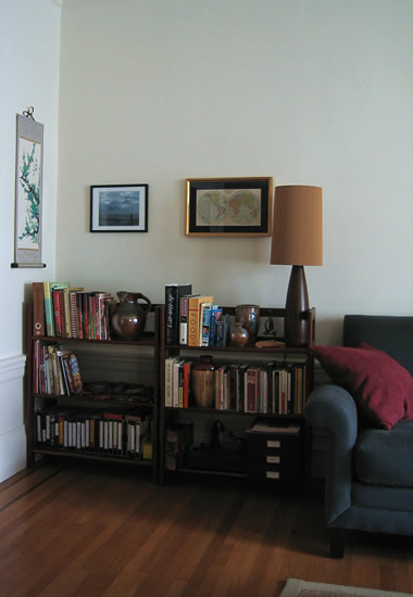 living room corner with pictures on the wall