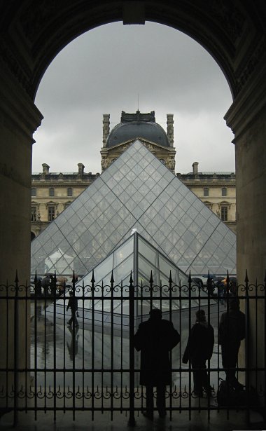 Louvre's glass pyramid seen through a wall