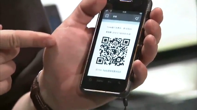 Screencap of a MeeGo demo video showing a QR Code pointing to http://justinsomnia.org/