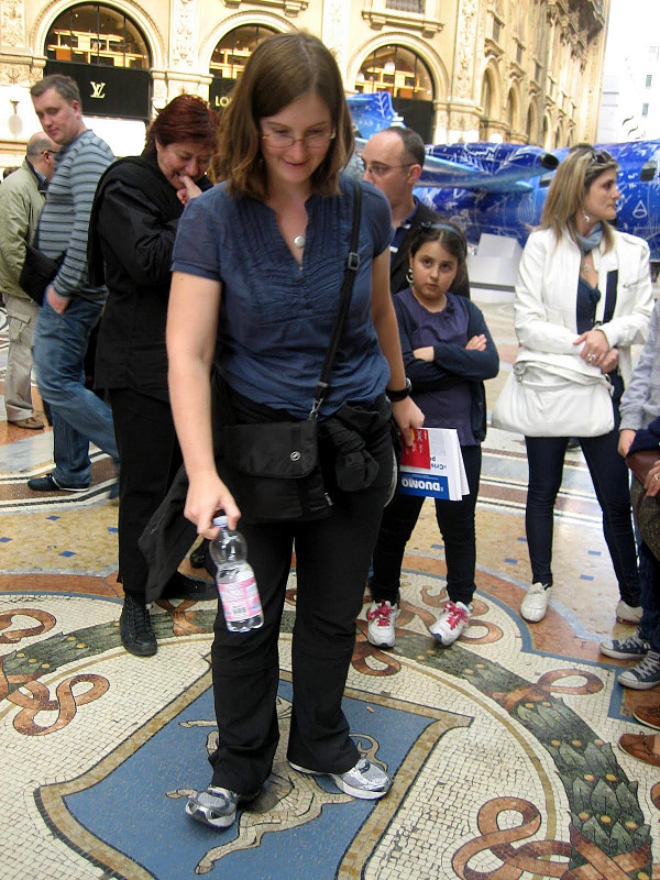 Katie spinning her heel in the lucky bull balls at the Galleria Vittorio Emanuele II in Milan, Italy (copyright Kathryn Watt)