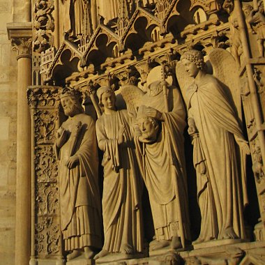 Dude holding his own head in the doorway of Notre Dame