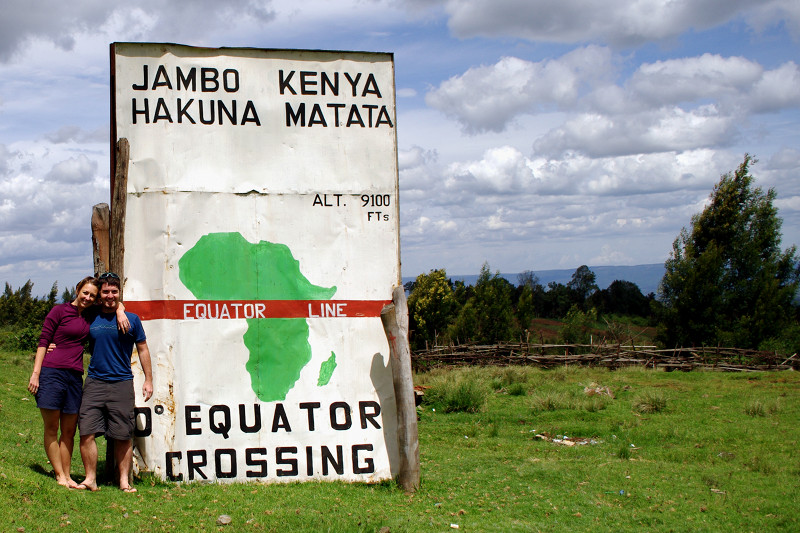 Stephanie and Justin standing on the equator in Kenya