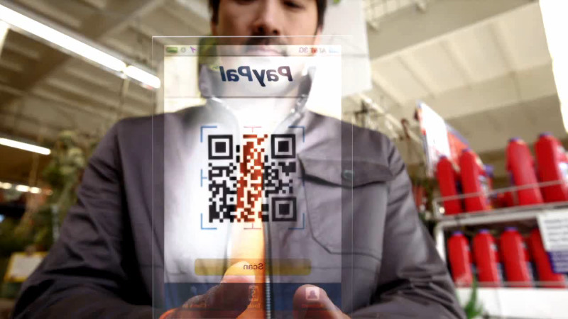 Screenshot from PayPal's Future of Shopping video using a QR Code that points to justinsomnia.org