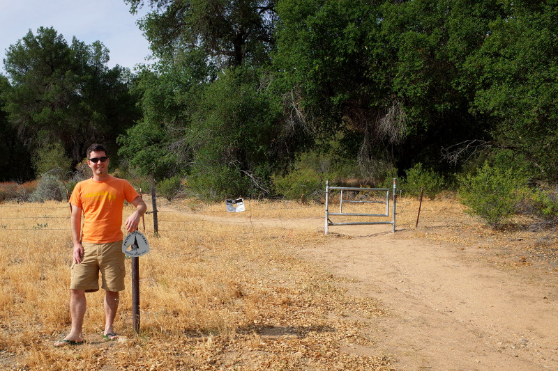 Justin posing with southbound trail marker where the PCT crosses California County Route S22