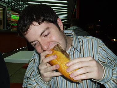 justin eating a geno's cheesesteak