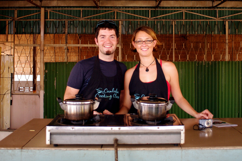 Justin and Stephanie behind the stove at Cambodia Cooking Class in Phnom Penh