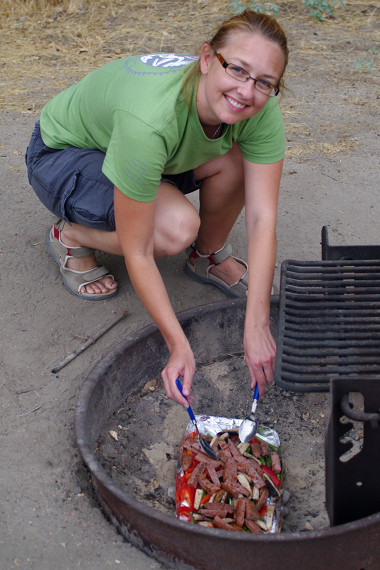 Stephanie cooking over hot coals