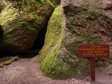 Pinnacles National Monument, sign reads: Caution, flashlights required, low ceilings, slippery when wet