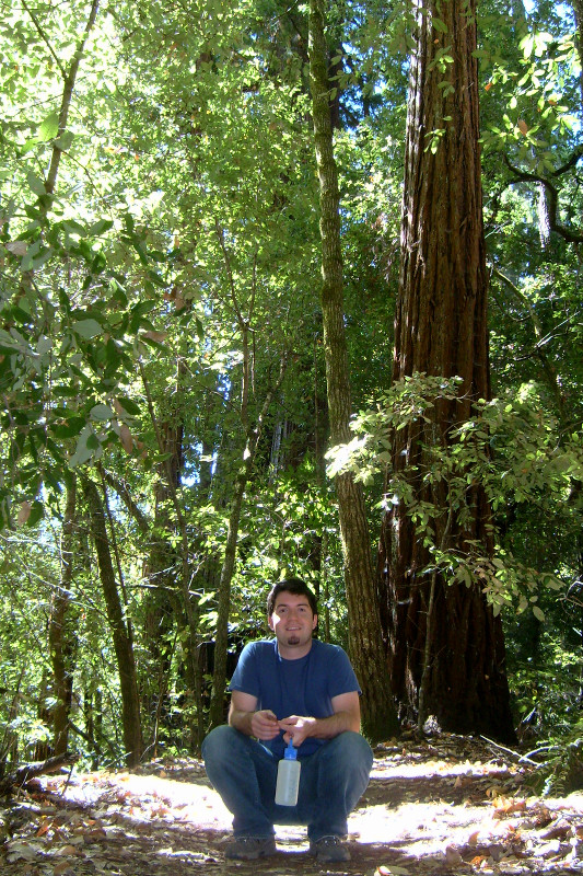 Justin squatting on the trail at Portola Redwoods State Park