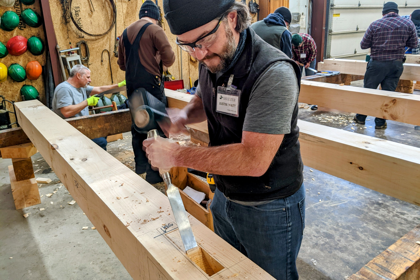 Justin roughing out a mortise with his timber framing chisel and mallet on day 2 of Shelter Institute's Purely Post & Beam class
