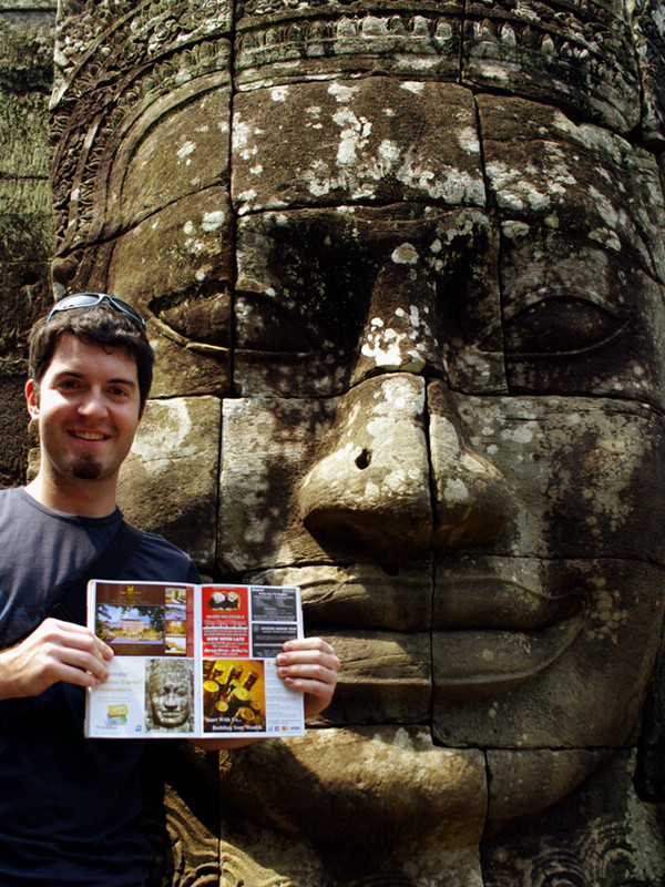 Justin posing with a smiling face in the Bayon temple at Angkor Thom with the magazine showing the same face from 2003