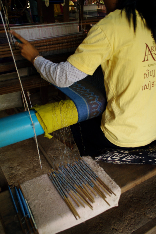 Creating a patterned silk scarf (or krama) on the loom in Siem Reap Cambodia