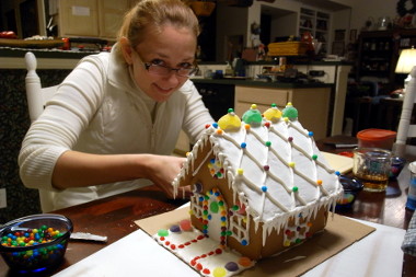 Stephanie building a gingerbread house