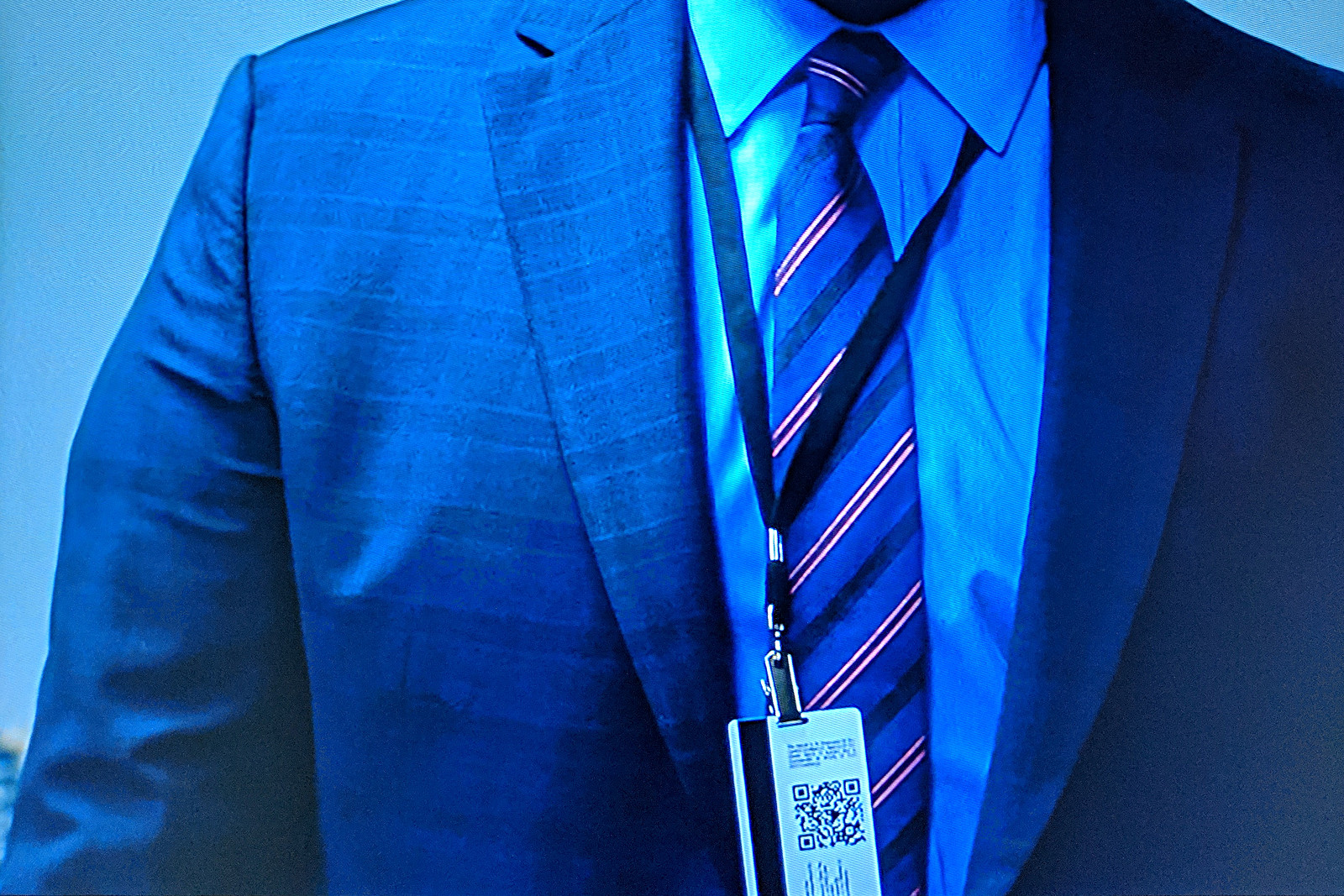 Screenshot from episode 1 of Tom Clancy's Jack Ryan, showing justinsomnia.org QR Code on James Greer's badge, close-up