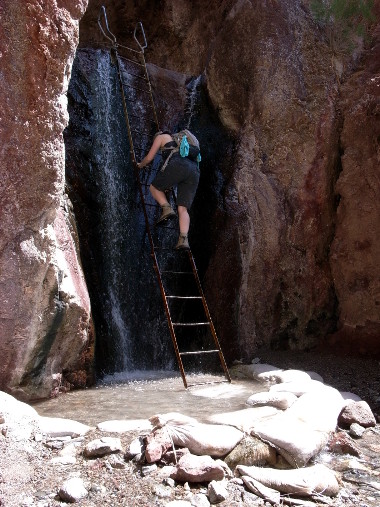 Stephanie climbing a ladder to reach the Arizona Hot Springs